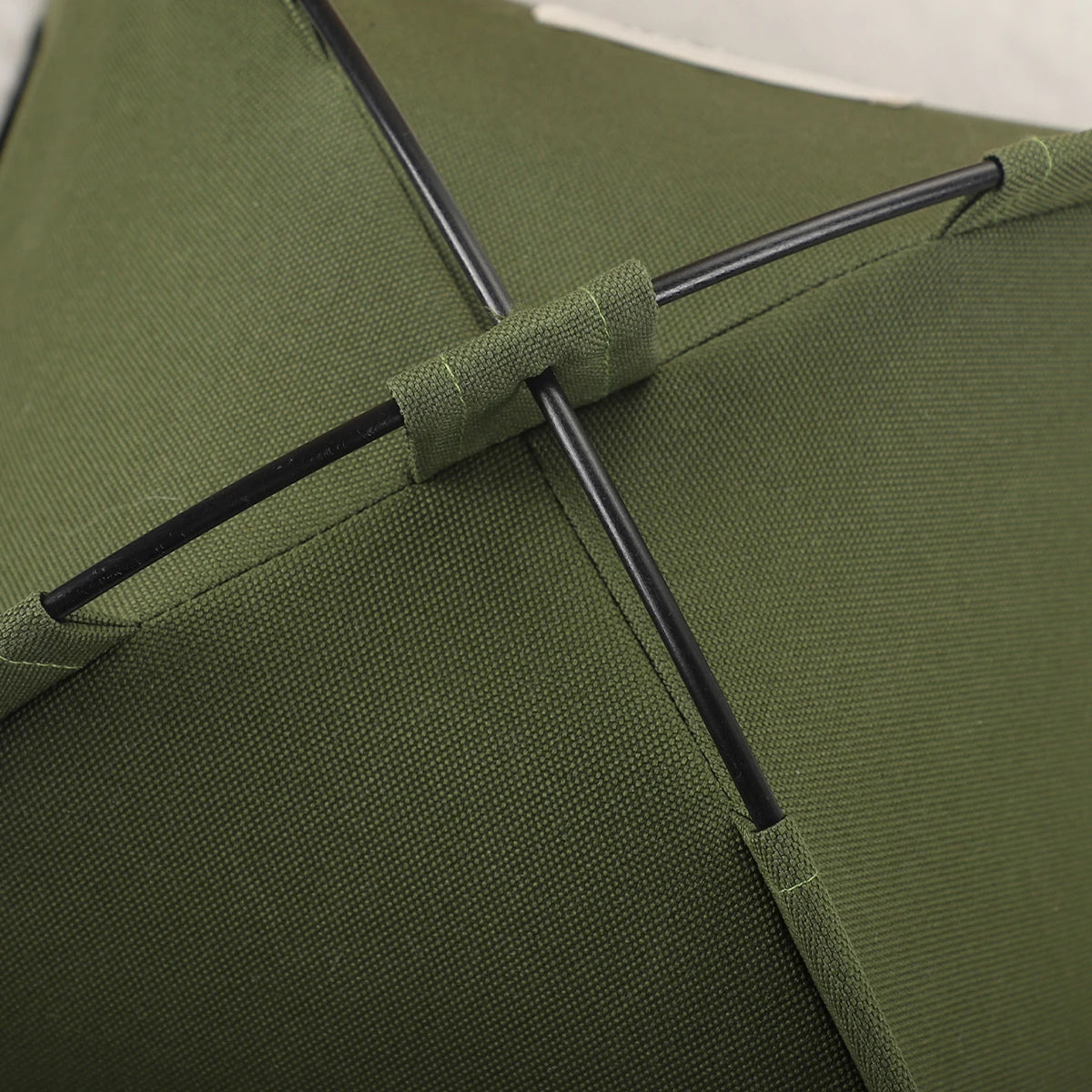 Close-up of the crossed support rods and fabric loops on top of the pet tent