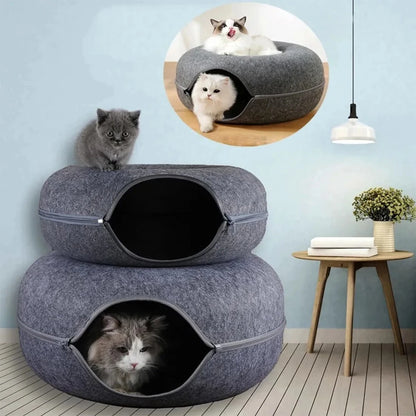 Two grey felt cat donut tunnel beds stacked into a two level tower with cats in a living room