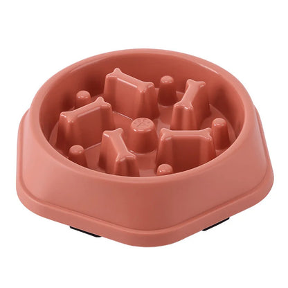 Pink maze slow feeder dog bowl on a white background, angled view of the empty bowl