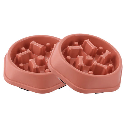 Two-piece set of pink maze slow feeder dog bowls on a white background