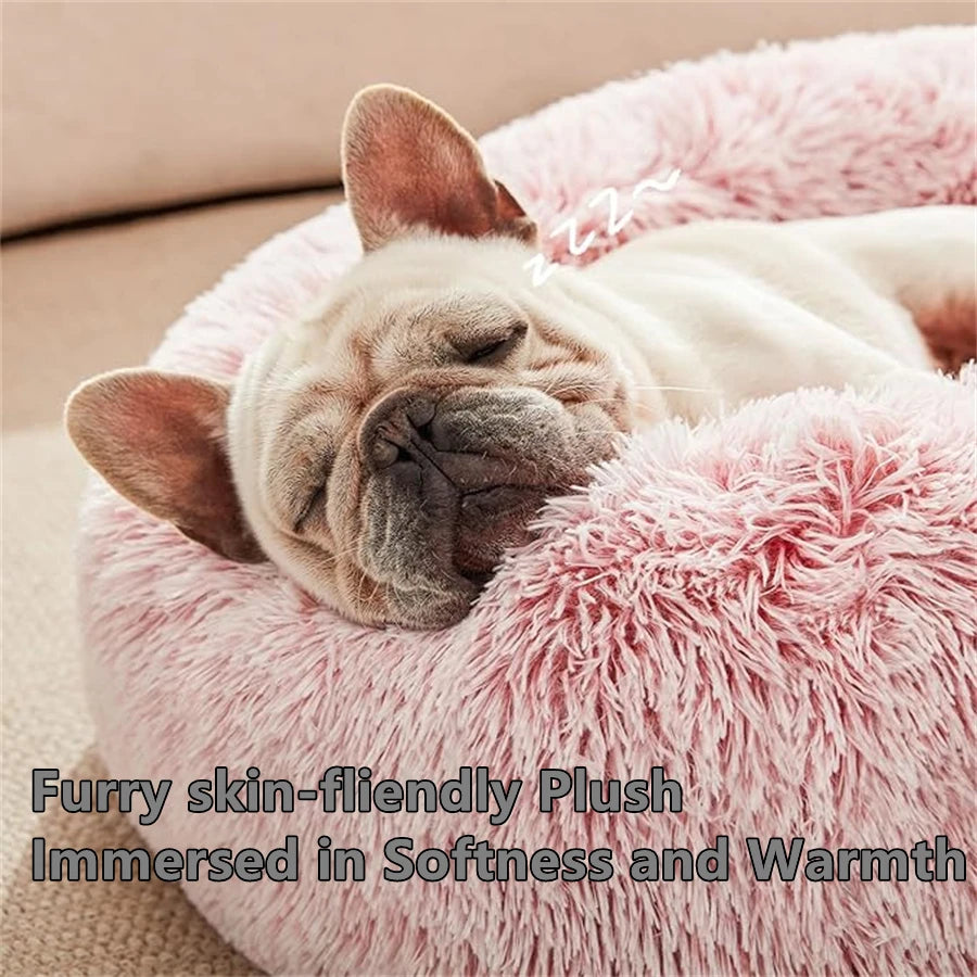 French bulldog asleep in a pink plush faux-fur donut pet bed