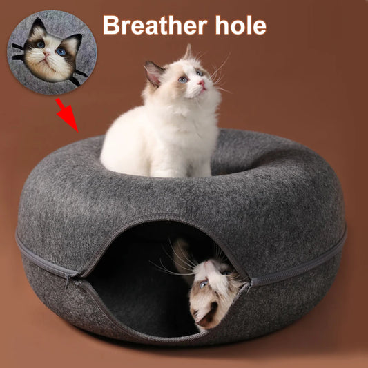 Dark grey felt donut cat tunnel bed with a kitten resting on the rim and another inside, breather hole marked