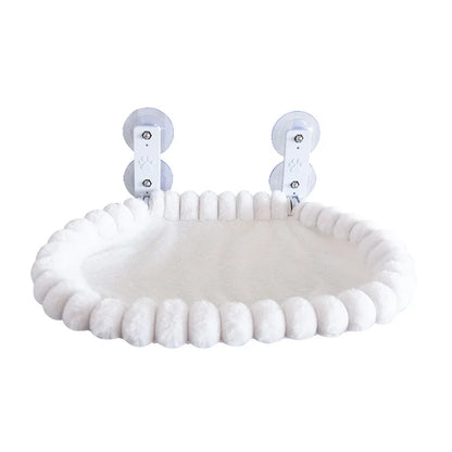 White pom-pom trim oval cat window hammock with two suction cup mounting brackets on a plain white background