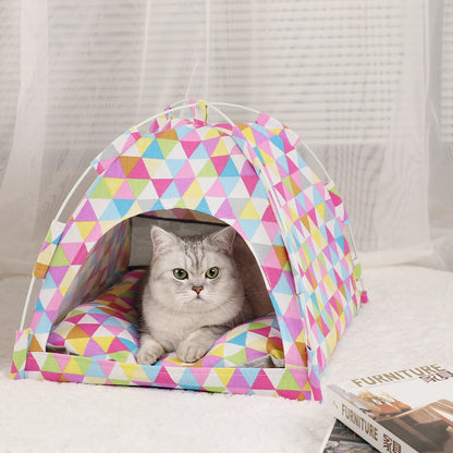 Colourful triangle print cat tent bed with a tabby cat resting inside