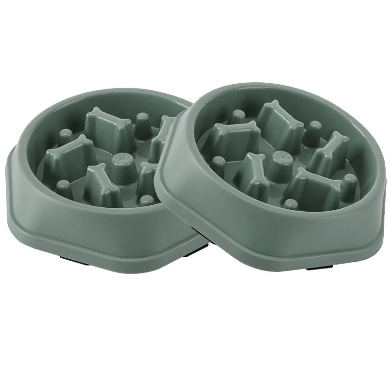 Two-piece set of green maze slow feeder dog bowls side by side on a white background