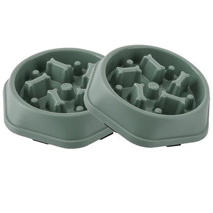 Two-piece set of green maze slow feeder dog bowls side by side on a white background