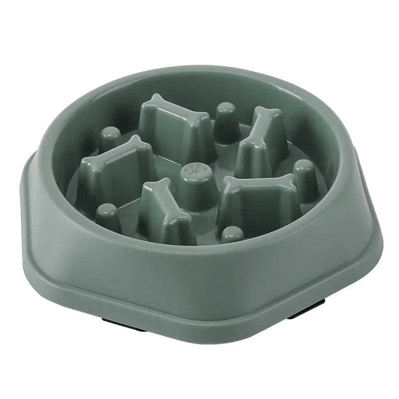 Green maze slow feeder dog bowl on a white background, angled view of the empty bowl