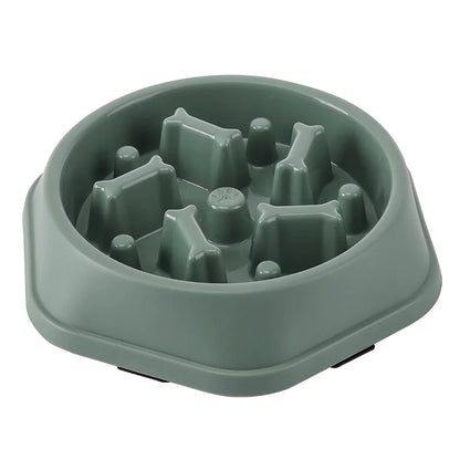 Green maze slow feeder dog bowl on a white background, angled view of the empty bowl