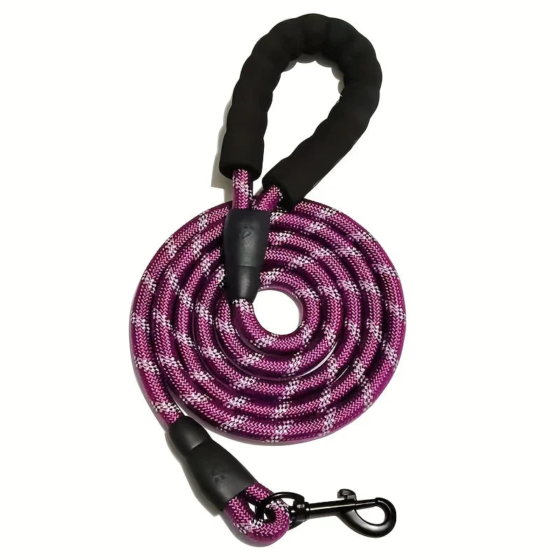 Pink reflective braided rope dog leash coiled with black padded handle and metal clasp