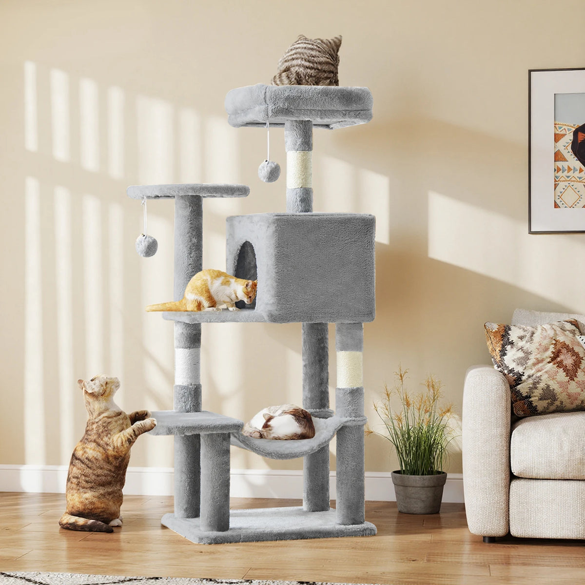 Light grey 43.6-inch cat tree in a sunlit living room with three cats using the top perch, condo and lower platform