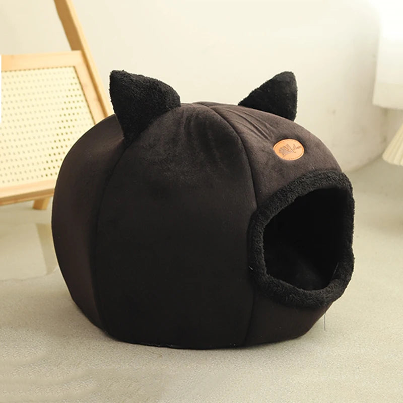 Side view of a black enclosed cat cave bed with cat-ear detailing