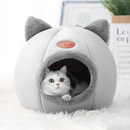 Light grey cat cave bed with cat ears and a cat looking out from inside