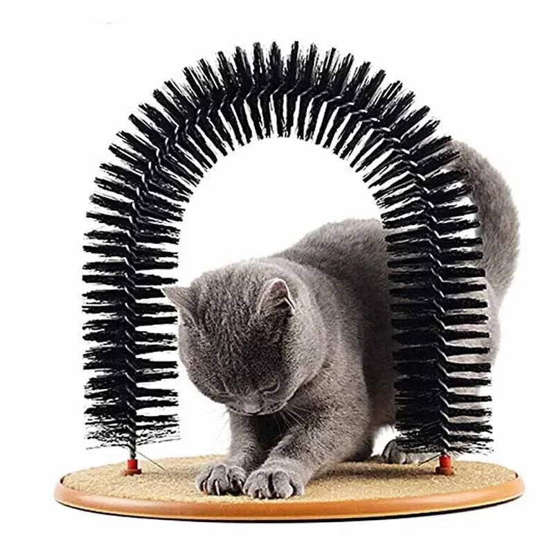Grey cat scratching the pad base while standing under the black bristle groomer arch