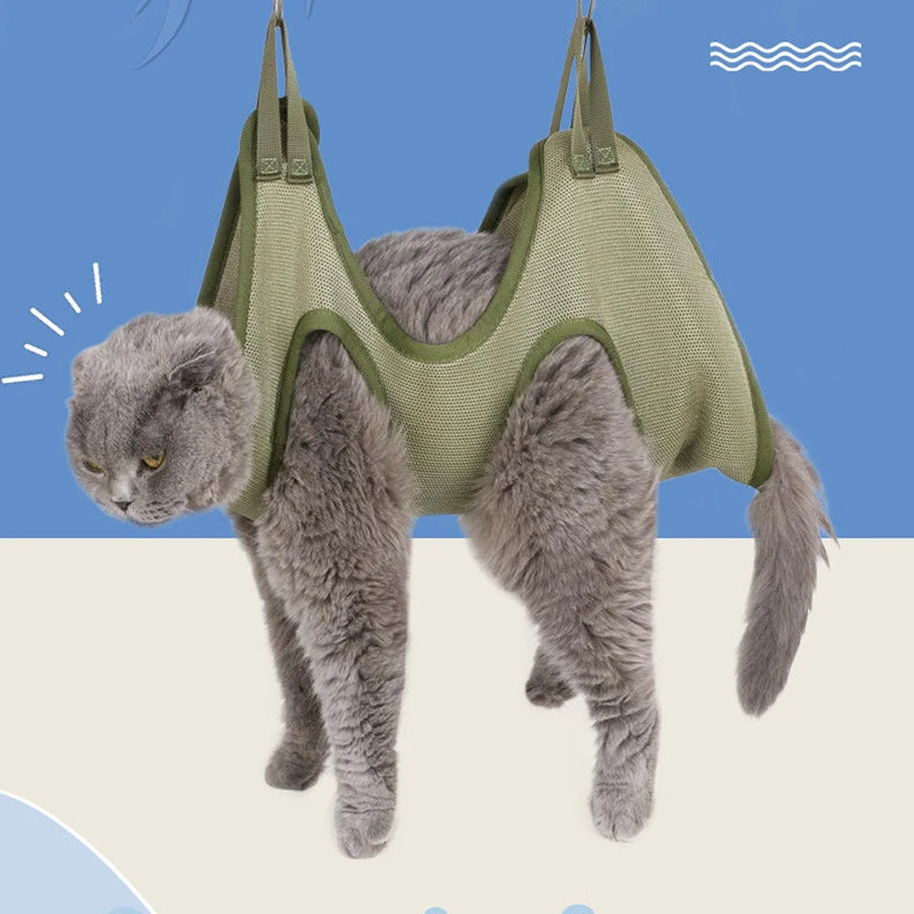 Gray cat suspended in a green mesh cat grooming hammock with all four paws hanging through the leg openings