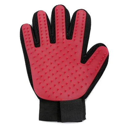 Red silicone pet grooming glove with black trim and wrist strap on a white background